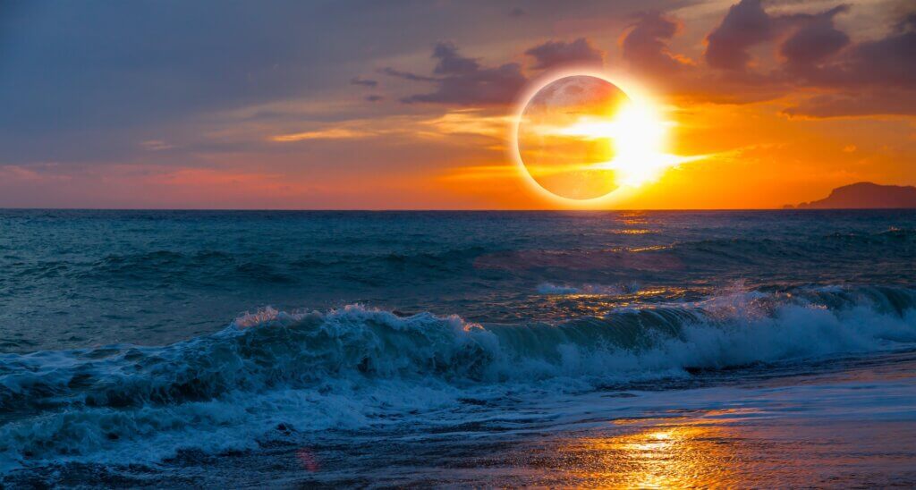 solar eclipse with ring of fire at beach